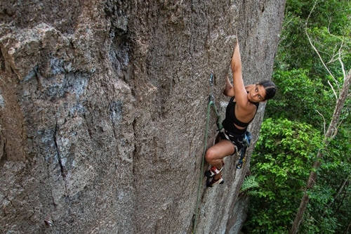 A sport climber eyeing the next move on a route in Koh Tao