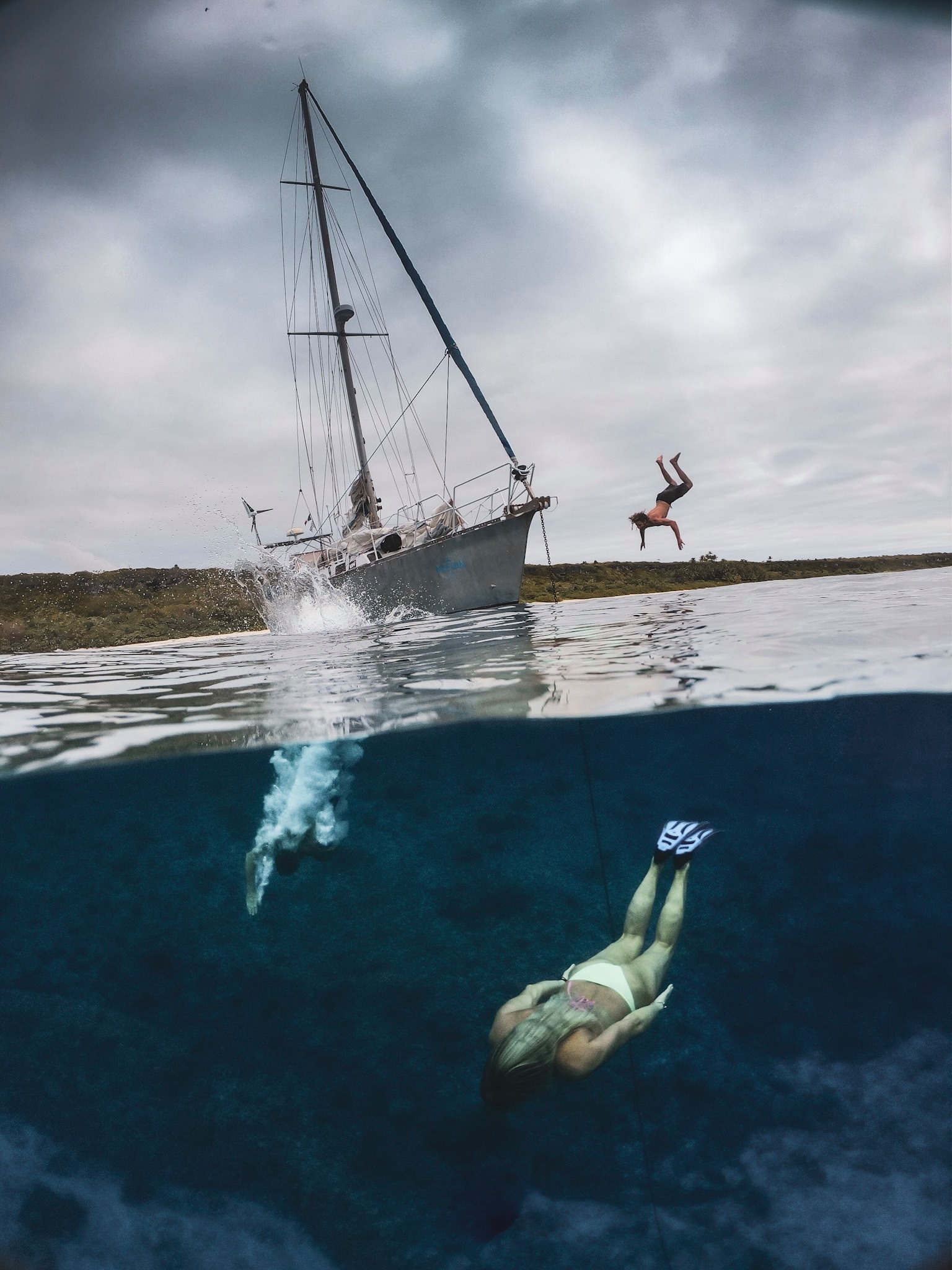 A person swimming near the Maewan boat, French Polynesia