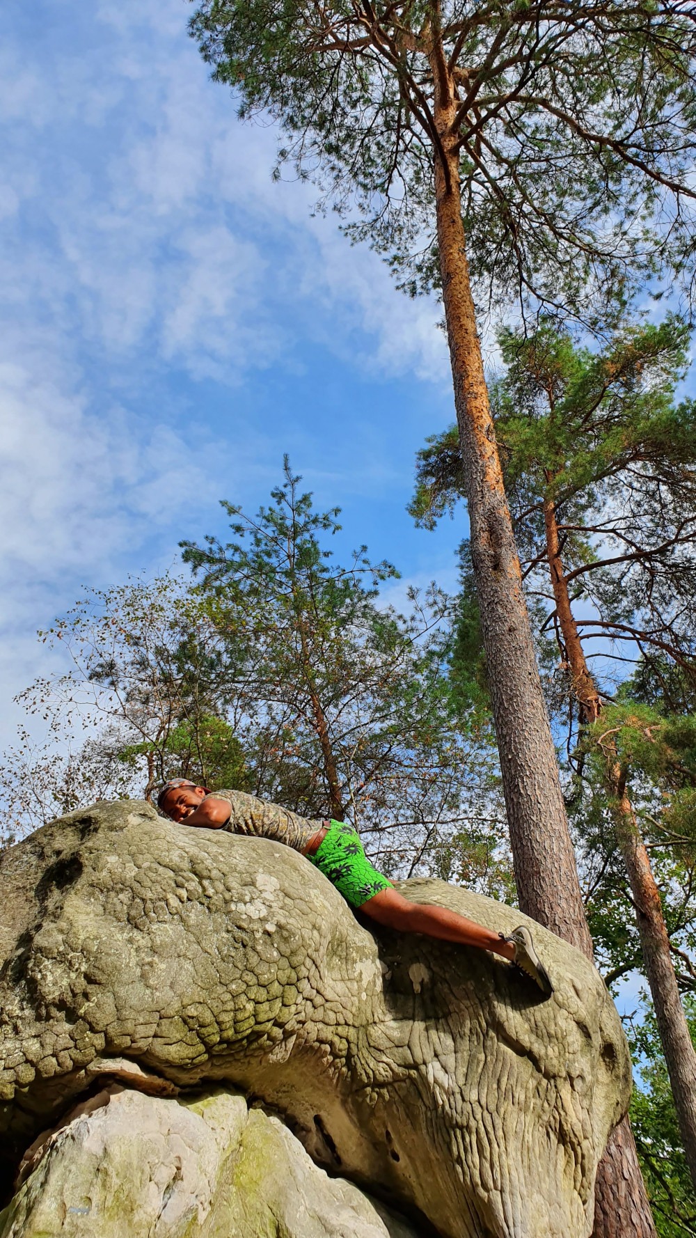 Topping out on a boulder in Fontainebleau