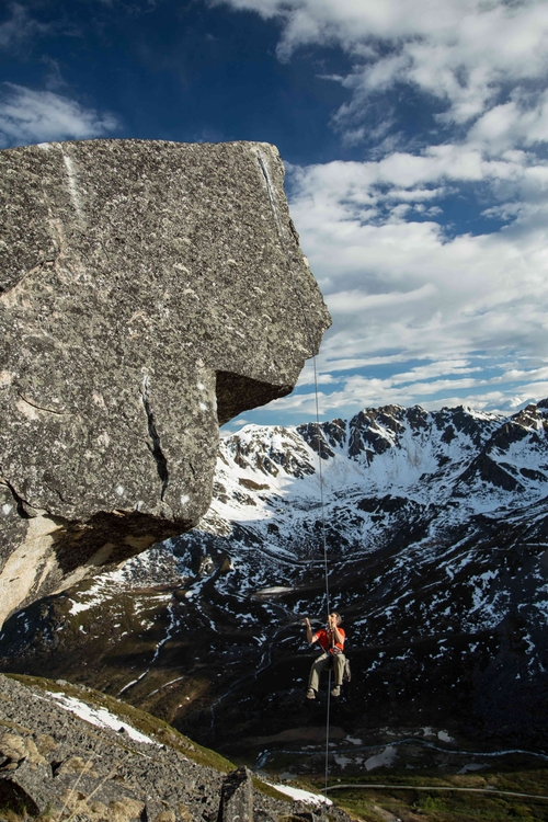 A climber rappelling off a climbing in Alaska