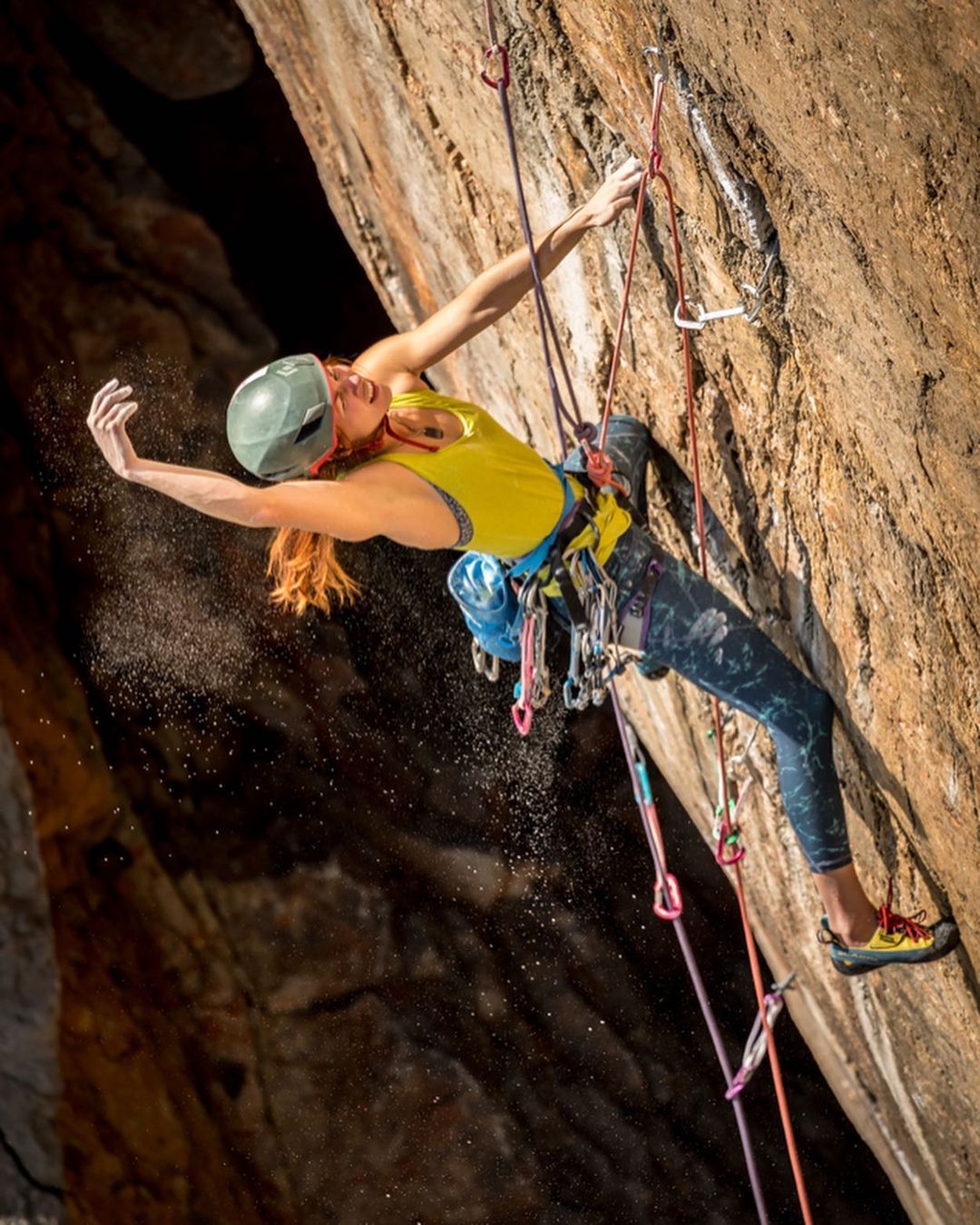 Emma Twyford shaking out while trad climbing