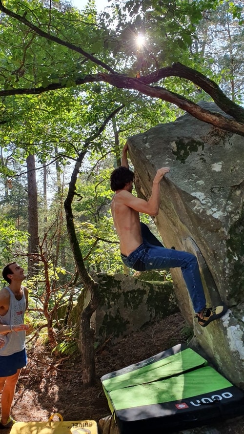 A climber bouldering in Mont Ussy