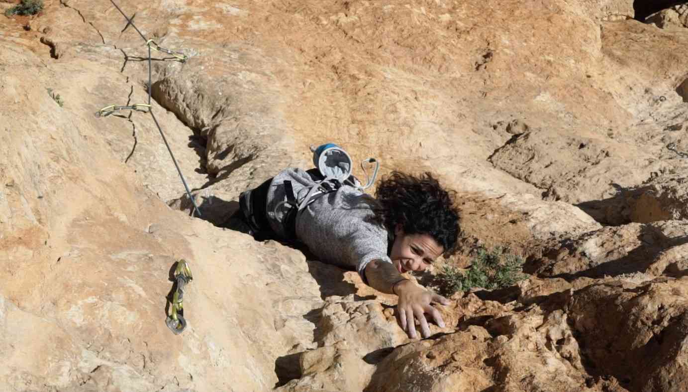 Climber reaching for the next hold in Palestine