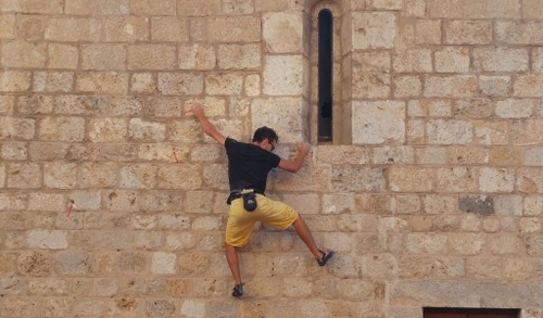 A person buildering: bouldering on a building
