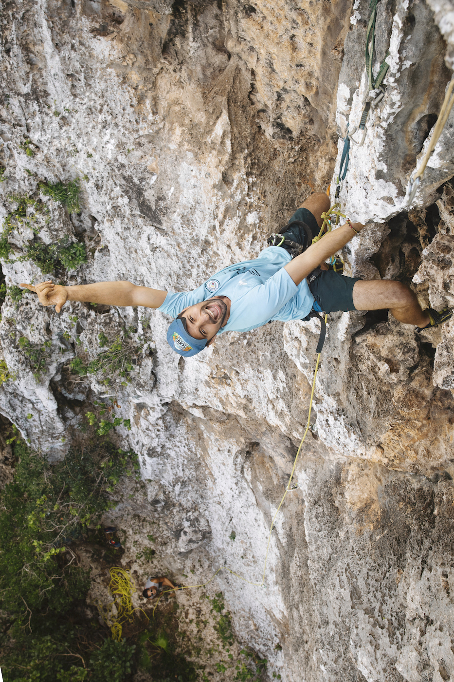 Rock climbing community Jamaica:  a climber waving on a sport route