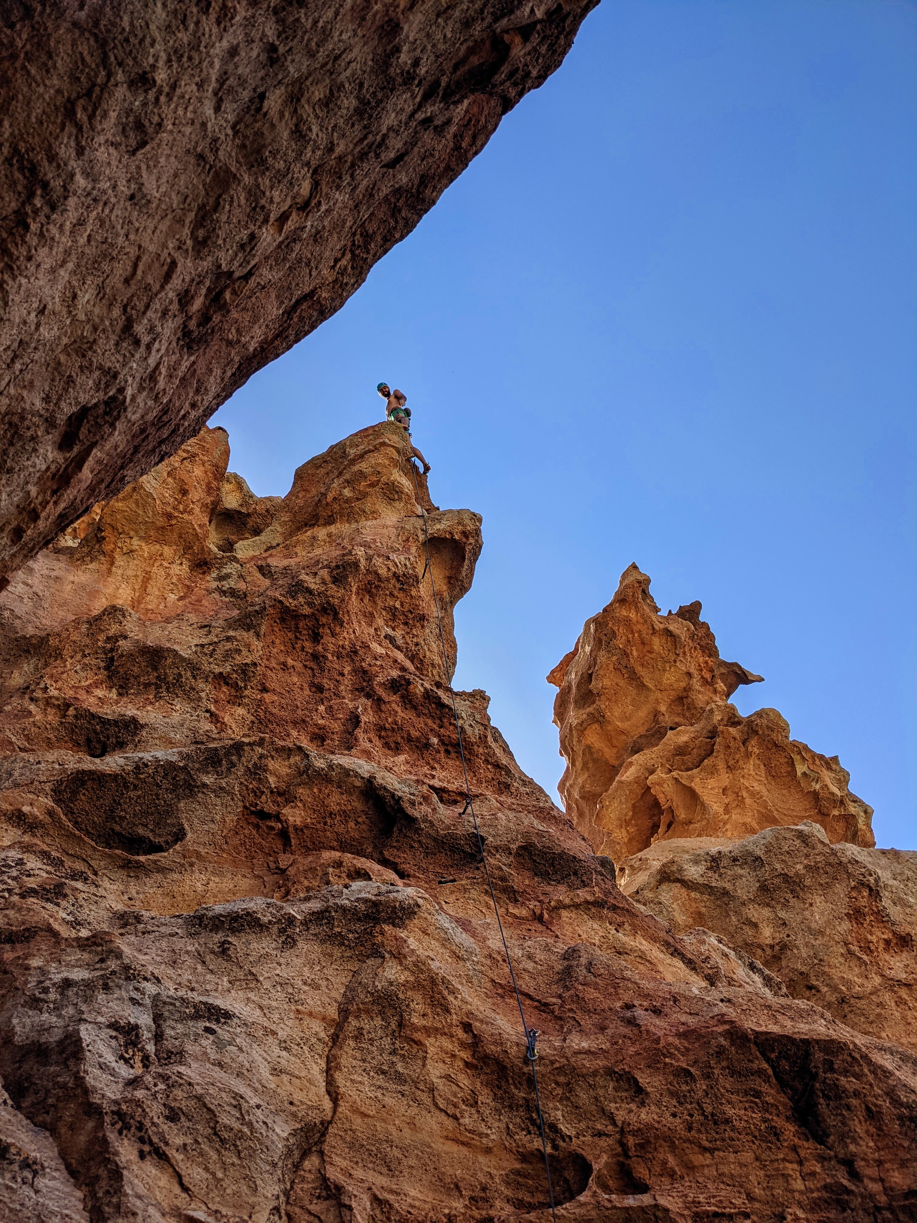 A climber topping out during a mental training for climbing course in Tenerife