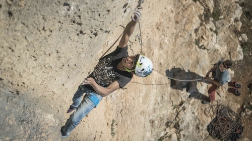 Sport climber clipping a quickdraw in Palestine