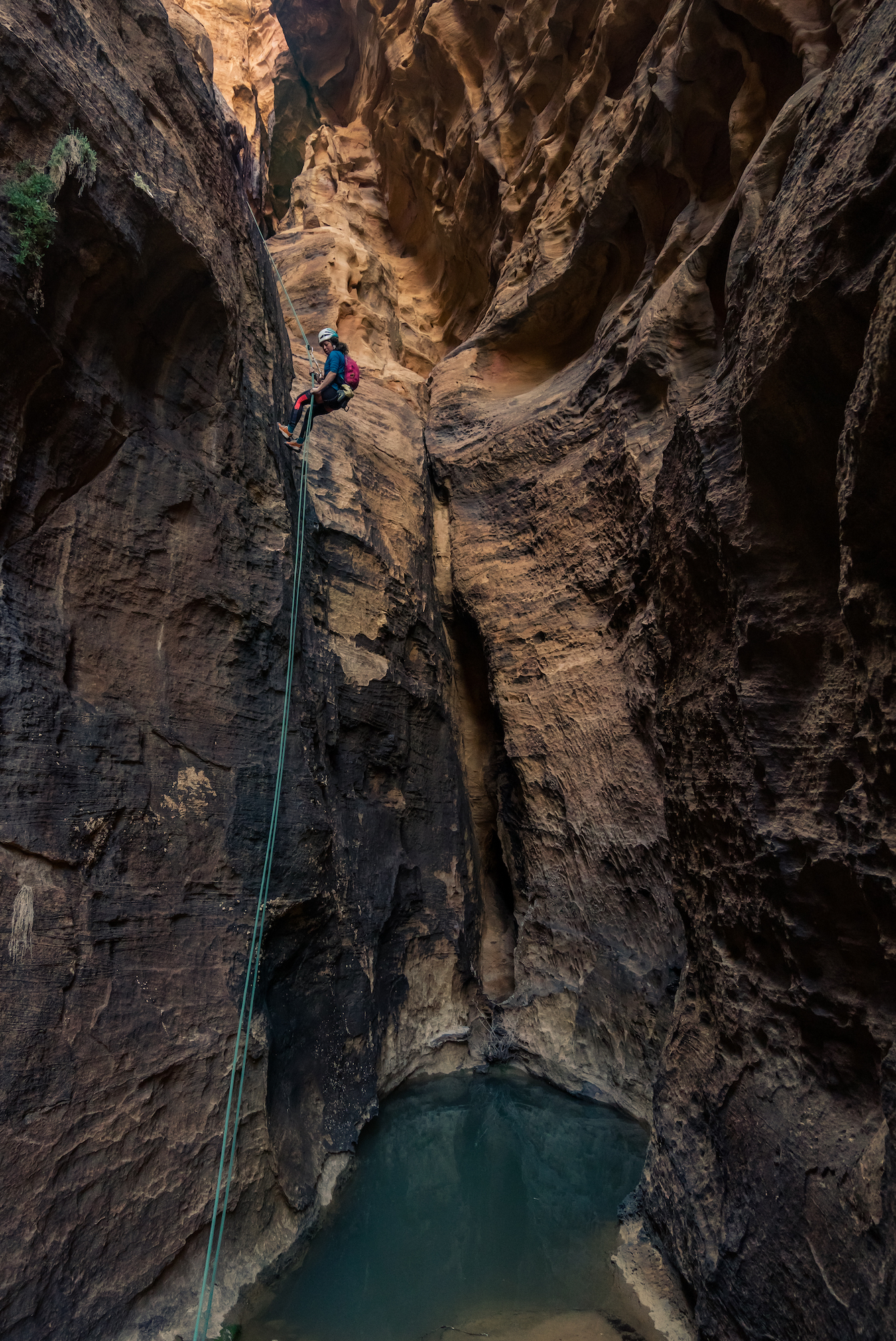 Rappelling off the top of a climbing route in Jordan