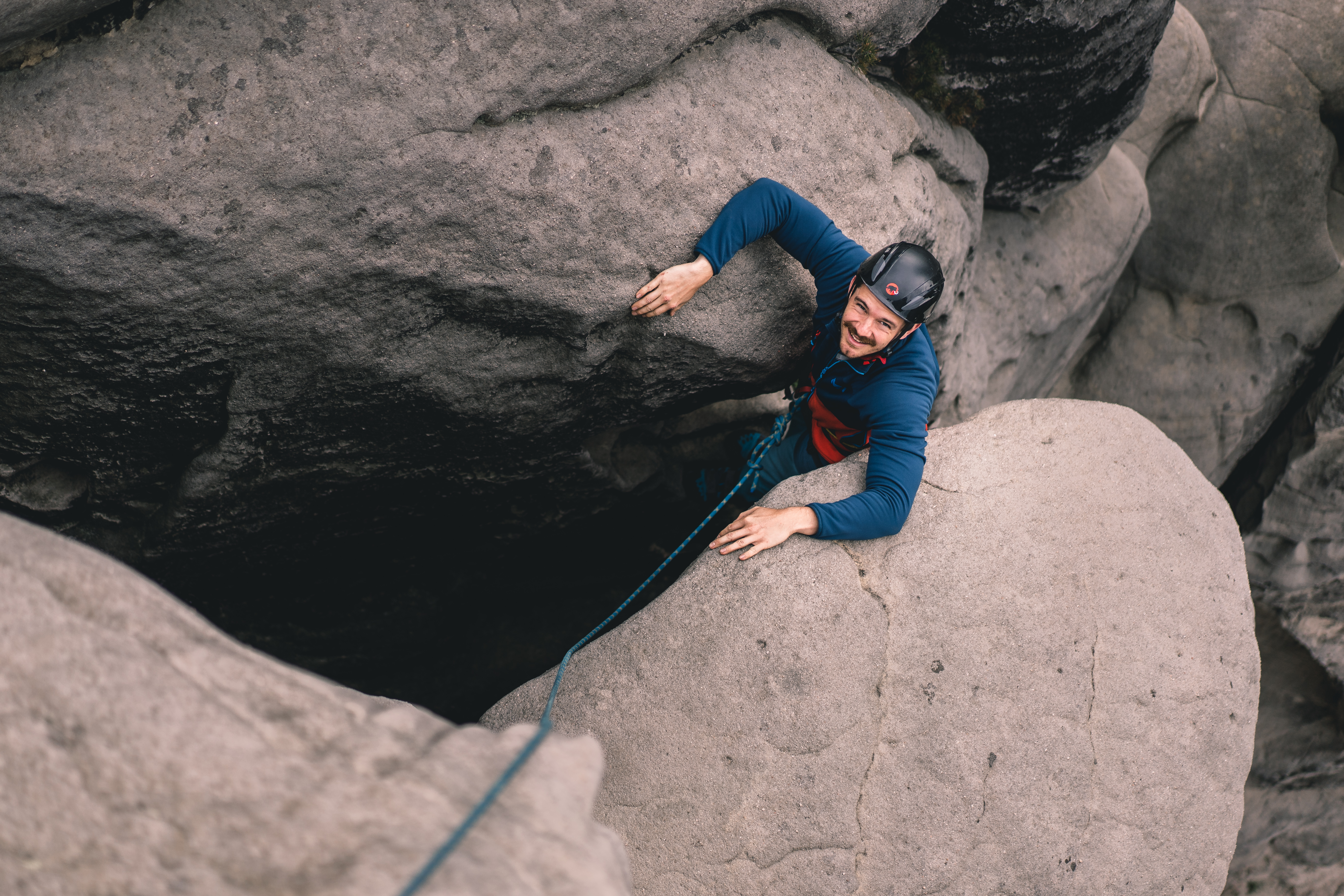 A rock climber demonstrating what layers to wear when climbing outdoors