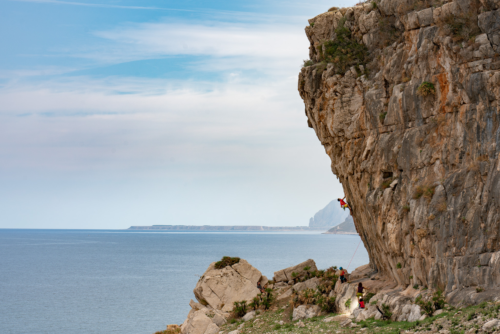 A climber on a cliff in Trapani, Western Sicily