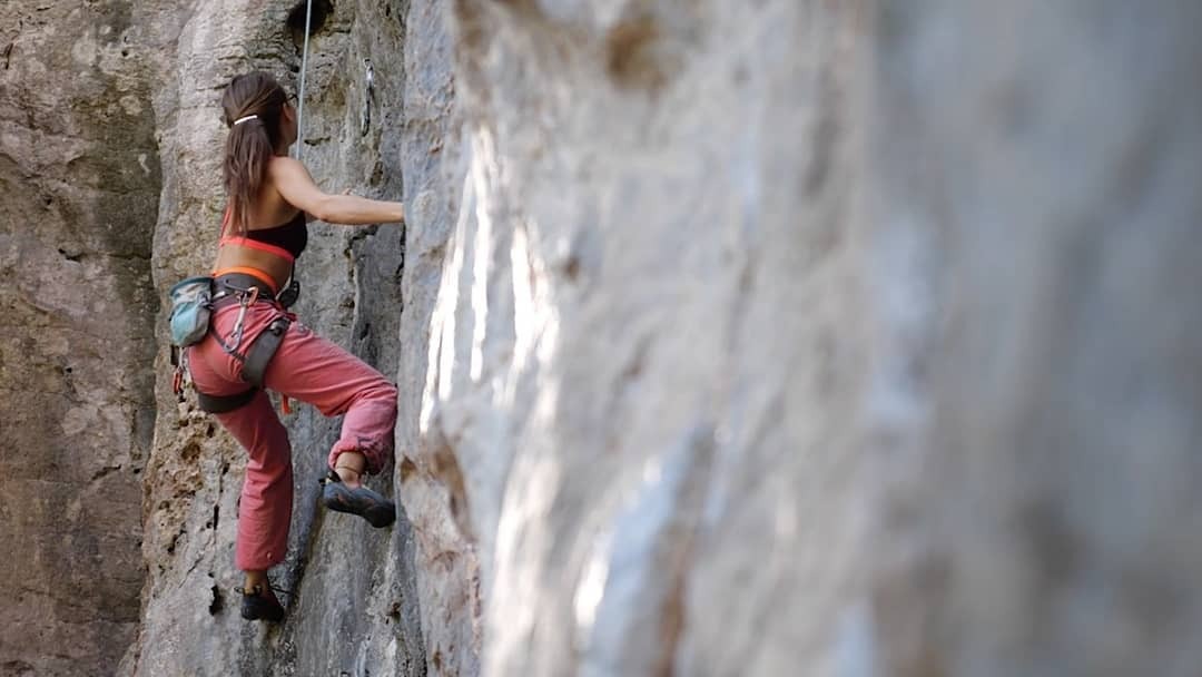 close up shot of a female climber on the walls of the valles de Vinales