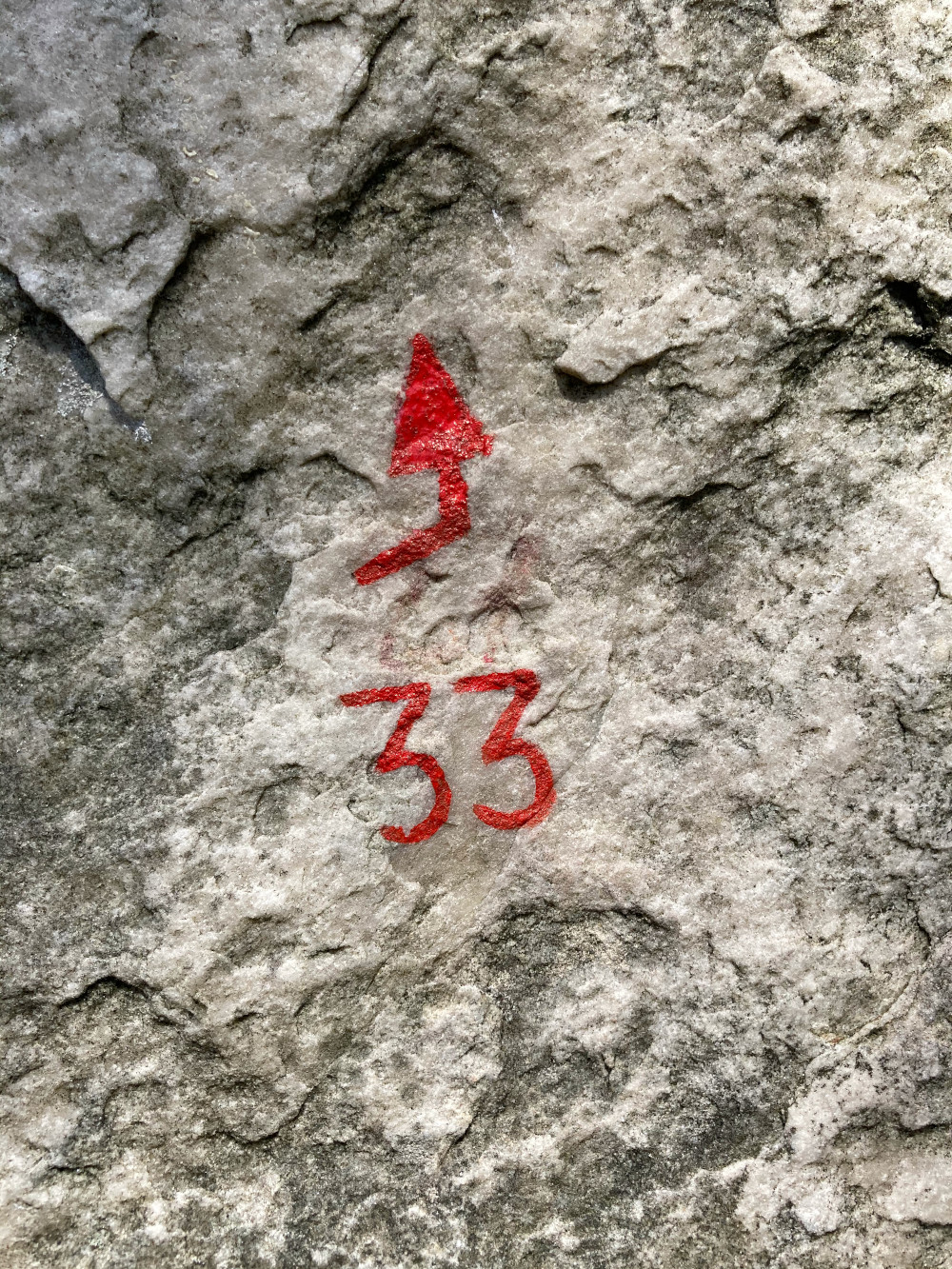 A close up shot of an arrow on a Fontainebleau boulder