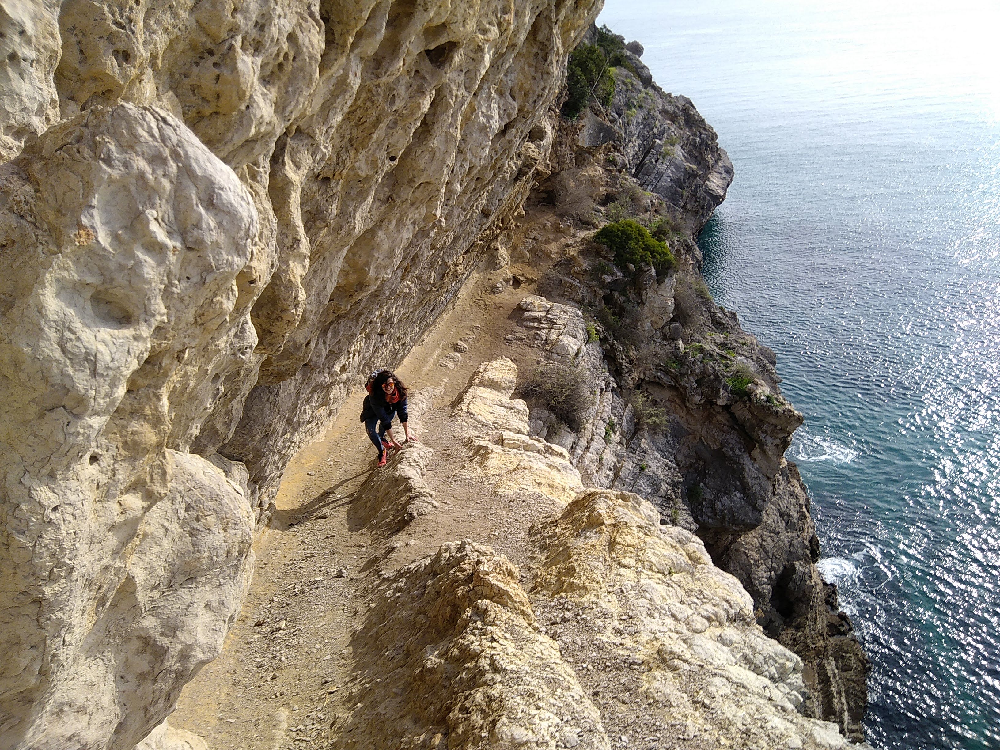 A person scrambling at a climbing crag near Lisbon, Portugal