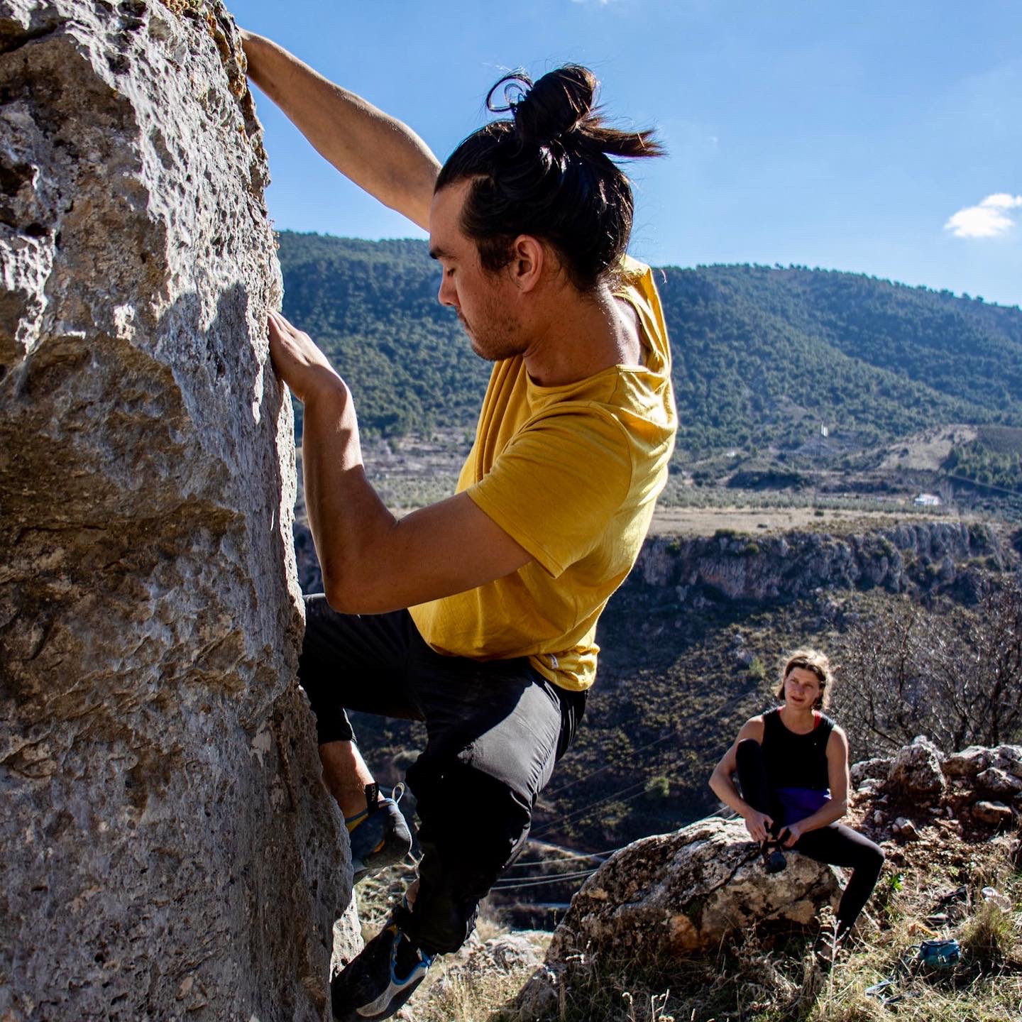 Close up shot of a climber on the limestone boulders at Cogollos