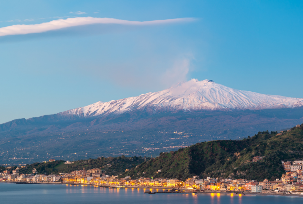 Mount Etna seen from the sea with snow ontop