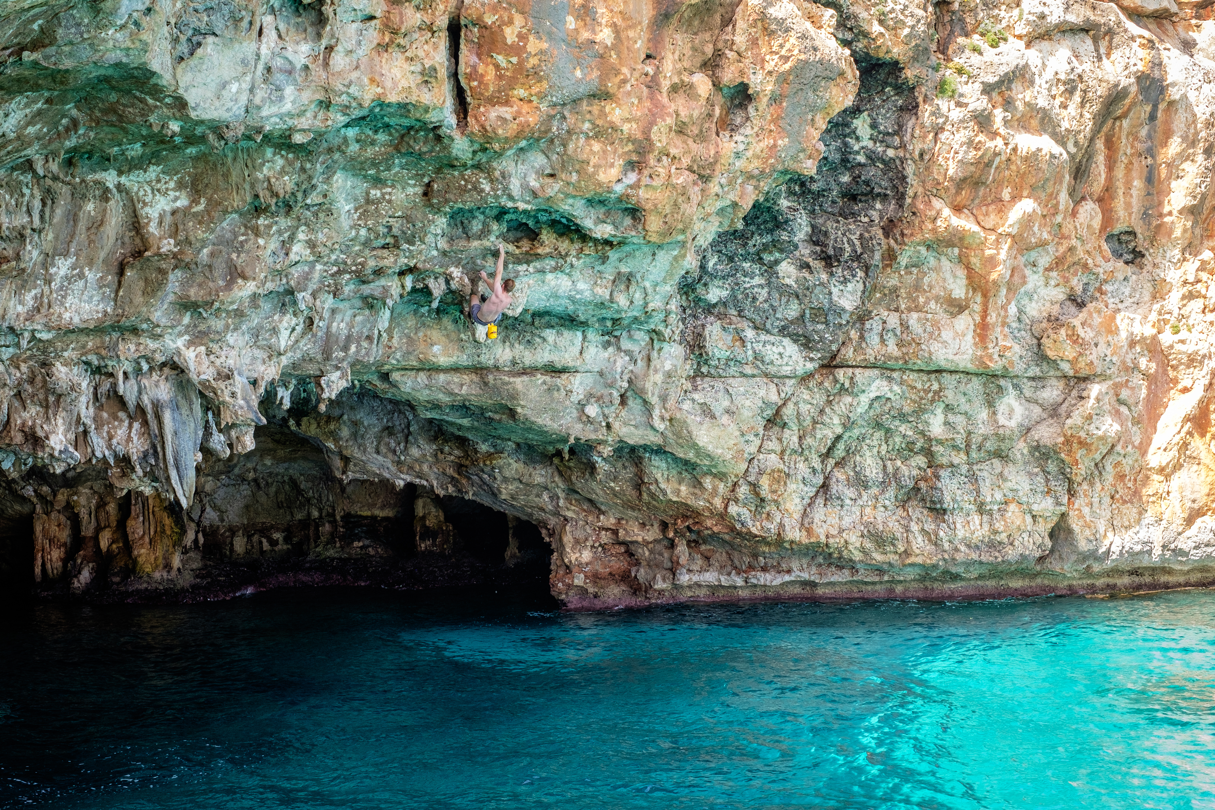 A person deep water soloing in Mallorca